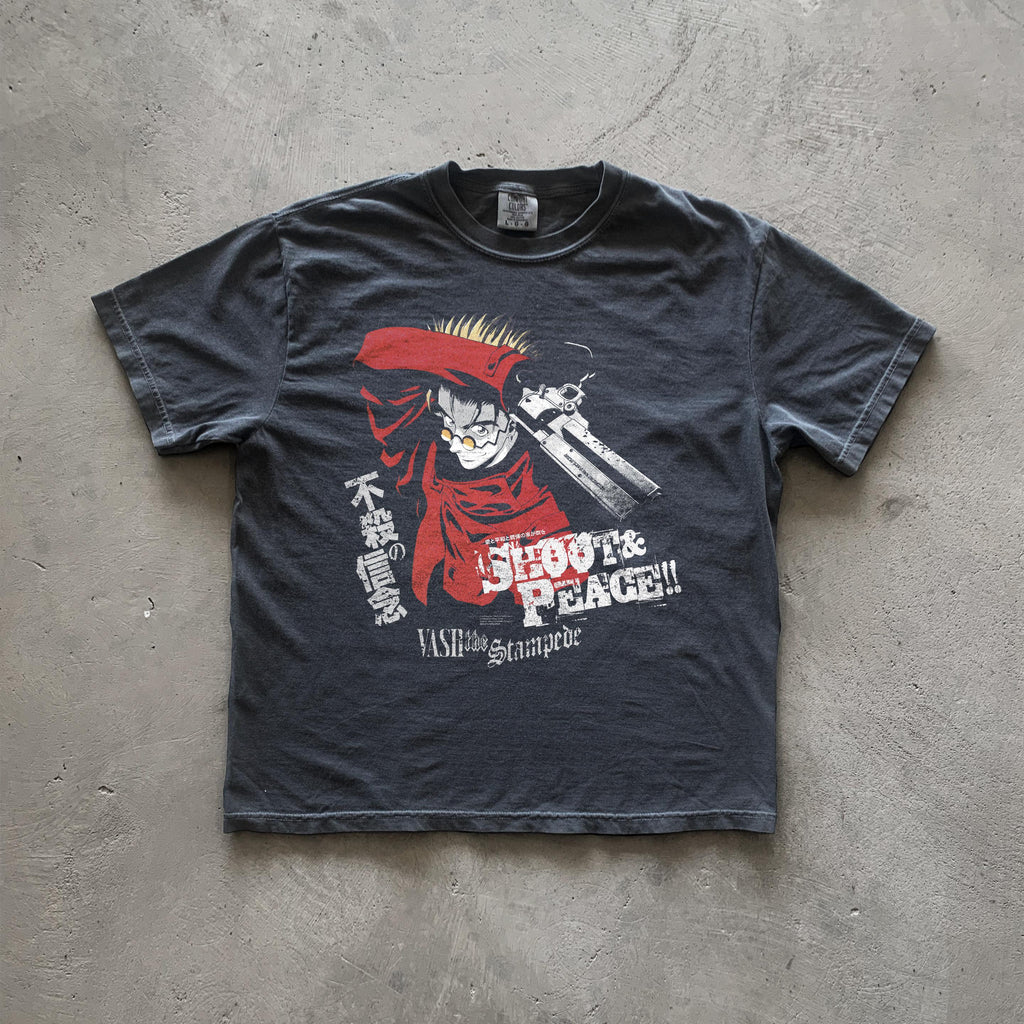 May include: A black t-shirt with a graphic print of a character from the anime Trigun. The character is holding a gun and has red hair. The text on the shirt reads 'Shoot & Peace!!' and 'Vash the Stampede'.